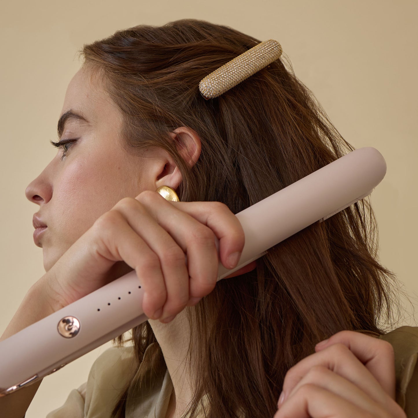a woman wearing a T3 barrette while styling hair