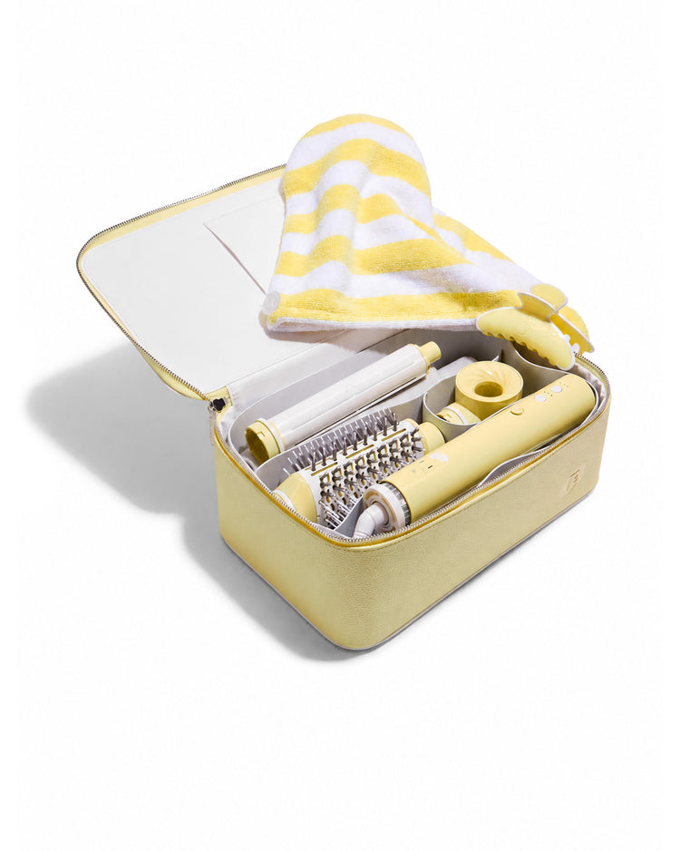 Yellow and white hair styling tool set in a case on a white background